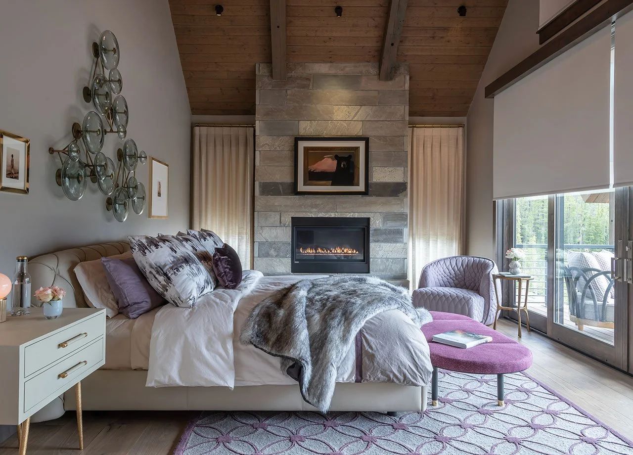 A cozy, modern Big Sky bedroom featuring automated Lutron shades and lighting design by SAV Digital Environments—combining luxury comfort with smart technology.