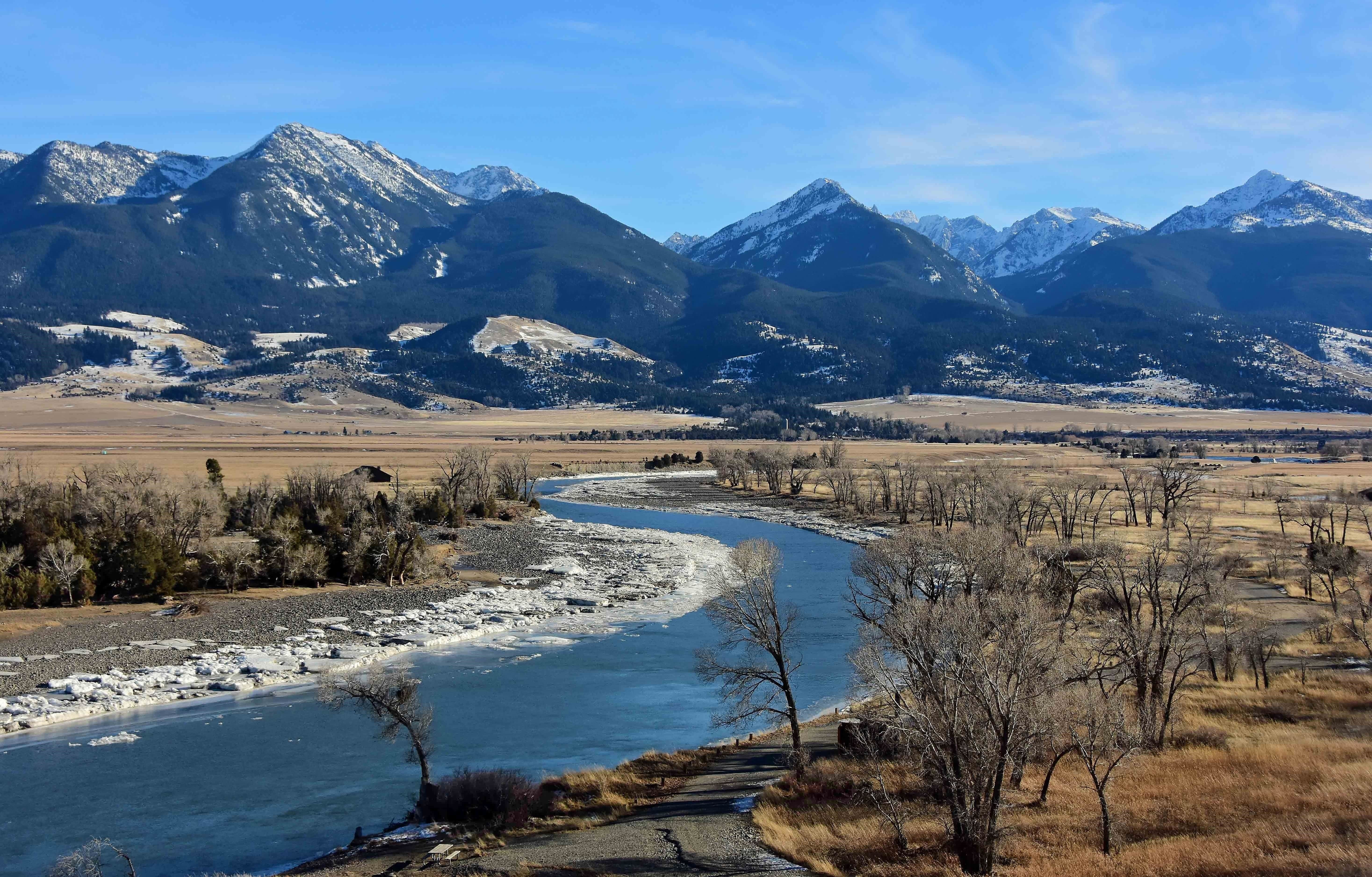 A scenic winter landscape on a sunny day at mallard's rest fishing access along the paradise valley scenic loop of the yellowstone river and gallatin range, south of livingston, montana